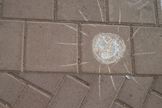 drawing in chalk on the asphalt sun