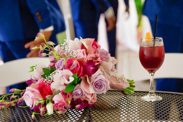 Wedding bouquet and cocktail on the table. Celebration background
