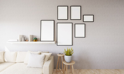 The living room is decorated with chairs, sofaand picture frames.