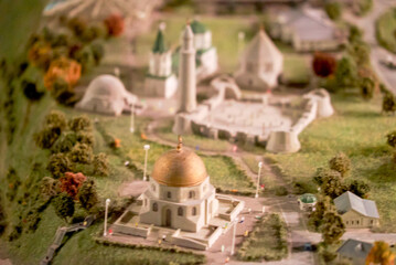 a miniature of a small village and a road. Miniature of trees and bushes. Beautiful buildings