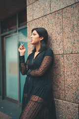 Obraz premium woman wearing a black dress smoking