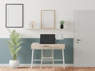 The working room is decorated with furniture with picture frames on the wall.