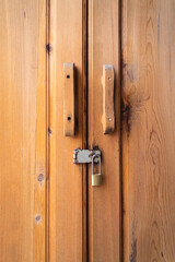 Double wooden door locked with a key