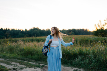 Young russian beauty is walking through a sand field with her hair loose and long