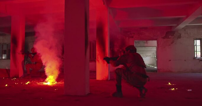 Masked Team of Armed Modern Warfare Soldiers Team Move in Tactical Formation in a Dark Urban Battlefield Indoors.Soldiers Squad with Rifles and Flashlights in action.