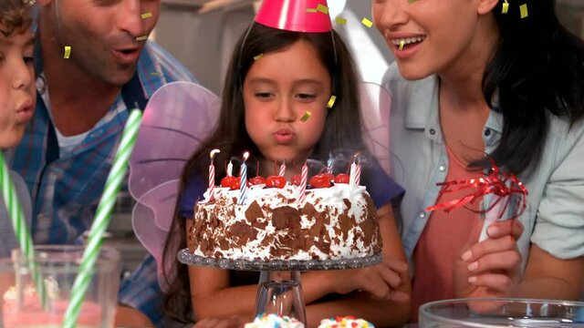 Animation of confetti falling over family having fun at birthday party