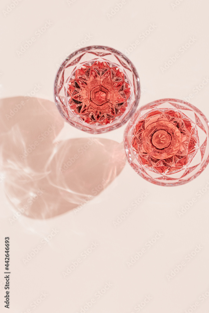 Poster two glasses of rose sparkling wine top view, fashion glass with beautiful pattern with dark shadows 