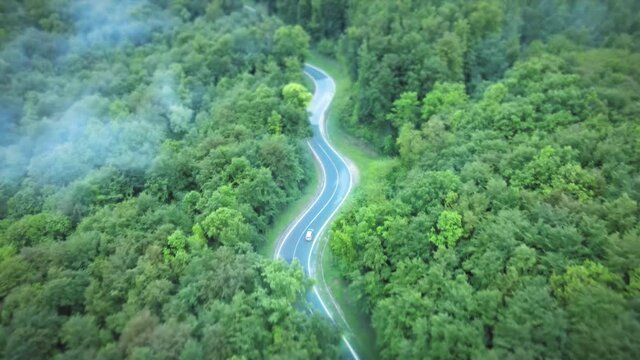 Aerial of self driving autonomous electric car with autopilot driving on road with glowing edges. Automated AI future concept with animation