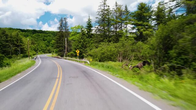 Driving a Car on a sunny day in the Catskill Mountains, New York - Powered by Adobe