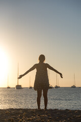 Woman enoying in  Cala Saona Beach in Formentera in Spain in summer 2021