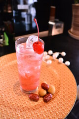 chilled cocktail pink glass alcohol sakura flower drink with cherry fruit and red date ice bar menu