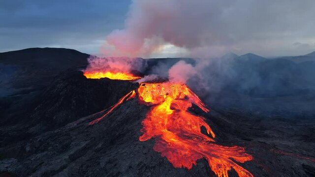 Beautiful Drone shoot  from smoking Iceland Geldingadalir Volcano Eruption. Lava and red hot magma flowing out from the crater.