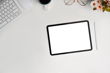 Top view digital tablet with blank screen on white table.