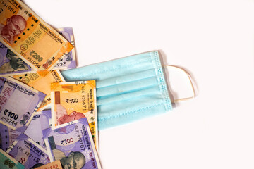 Indian rupee and protective face masks isolated on white background.