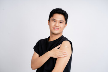 Asian handsome young man receiving coronavirus vaccine on white background He was smiling and happy...