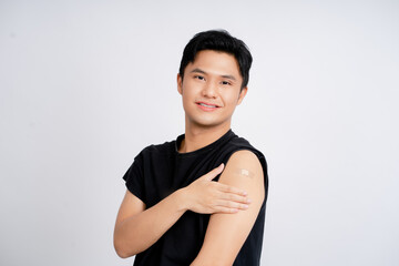 Obraz premium Asian handsome young man receiving coronavirus vaccine on white background He was smiling and happy with the results.