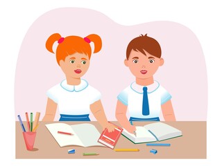 Schoolchildren are sitting at a desk. The concept of raising children of primary school age.