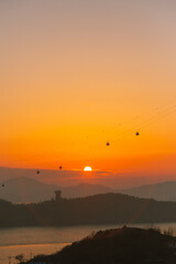 orange sunset with ocean and island