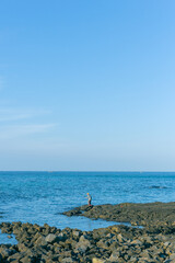 Fototapeta premium blue sky and ocean with fishing man