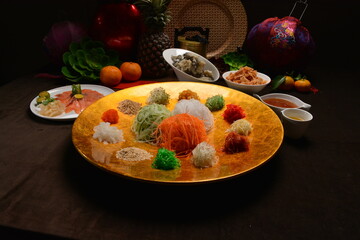 fresh colourful asian vegetables salad lo hei yu sheng with smoked salmon and sauces buffet for chinese new year menu