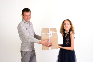 Dad gives a big gift to his daughter on a white background