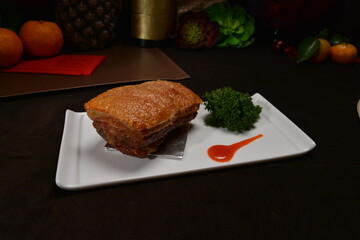 crispy roasted bbq pork belly meat cut slices in long plate Hong Kong banquet menu