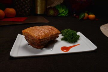 crispy roasted bbq pork belly meat cut slices in long plate Hong Kong banquet menu