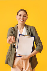 Real estate agent with key from house and clipboard on color background