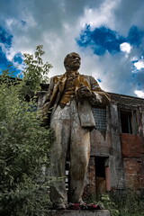 Lenin Monument on the background of an abandoned building in Novokuznetsk, Kemerovo region, Russia