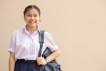 Asian School girl teen cute student in uniform happy smile with bag looking camera with space for...