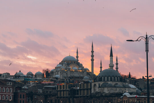 Old mosques and houses against sunset sky