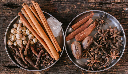 mix of Asian Indian dry herbs for alternative medicine or aromatherapy and food flavouring ingredient lay topview on wooden background.