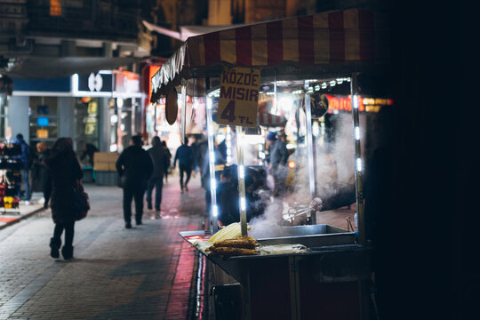 Vendor selling food on street in downtown at night
