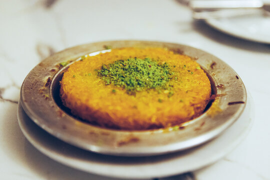 Fresh delicious Turkish dessert Kunefe with pistachio powder