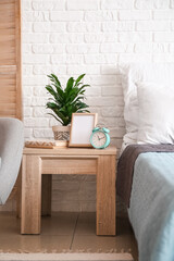 Interior of stylish bedroom with alarm clock