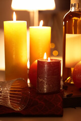 Burning candles on table in room