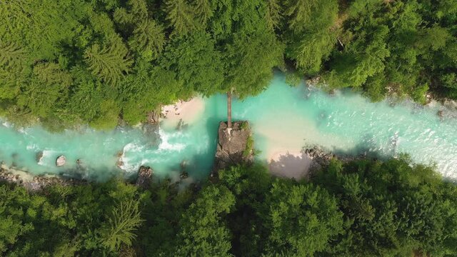 Aerial &ndash; Zomming in on a hanging bridge that is set over a majestic Soča river