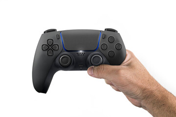 Male hand holding a Next Generation black game controller isolated on white background.