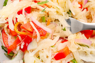 Tasty sauerkraut and fork on plate, closeup