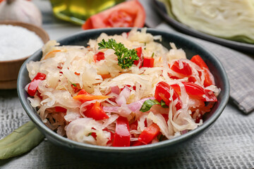 Bowl with tasty sauerkraut on wooden background