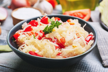 Bowl with tasty sauerkraut on table