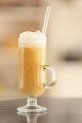 Glass of tasty iced coffee on table