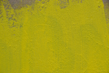 Yellow concrete wall with paint drips. Bright background with place for text.