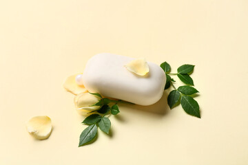 Soap bar and flower on color background