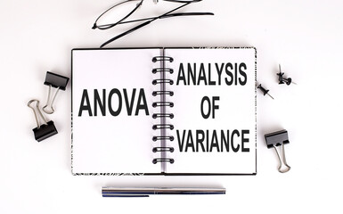 Notebook with ANOVA ANALYSIS OF VARIANCE on a table - obrazy, fototapety, plakaty