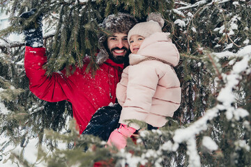Happy loving family! Father and his baby are playing and hugging outdoors. Little child and daddy on a snowy winter walk in nature. Concept of the first long-awaited winter snowfall. copy space