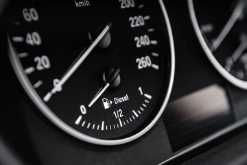 Close up of low fuel guage shown in a car.