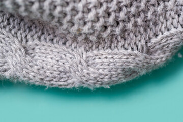 Fragment of a gray knitted plaid close-up. 