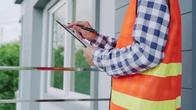 Slow motion VDO. house inspection agentengineer recheck final inspection of the house for deliver the house to the customer. Inspector is writing correction point for contractor to make corrections.