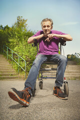 Older man overcoming obstacles with his four wheel rollator walker